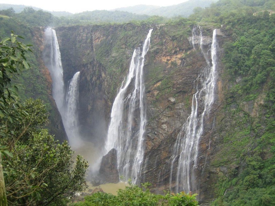 A waterfall cascading through forested cliffs in Pachmarhi